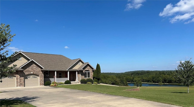 view of front of house with a garage, a water view, a porch, and a front yard