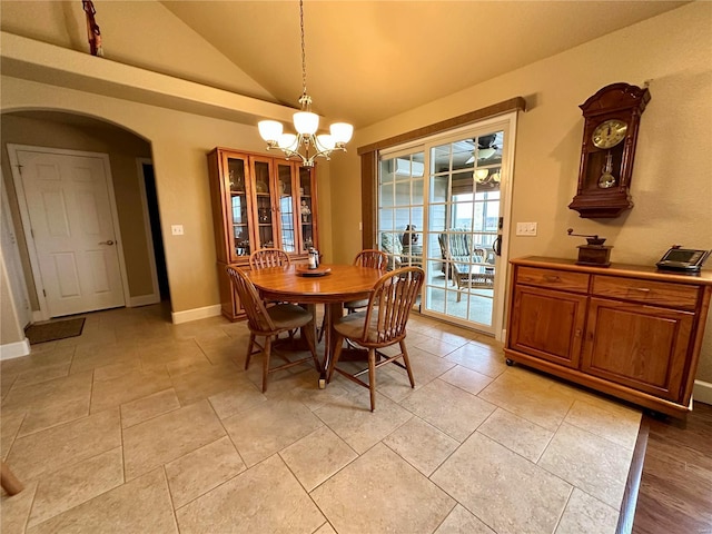 dining room with a notable chandelier and high vaulted ceiling