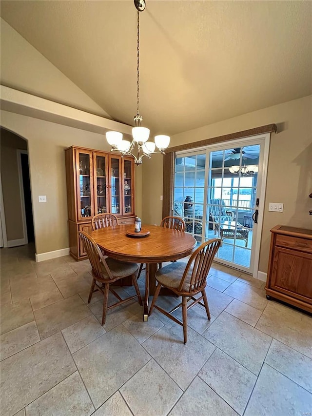 dining area featuring lofted ceiling and an inviting chandelier