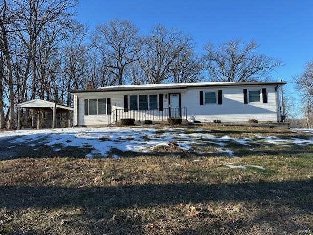 view of front of home featuring covered porch and a carport