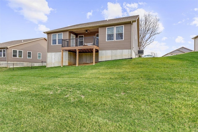 back of house featuring ceiling fan and a yard