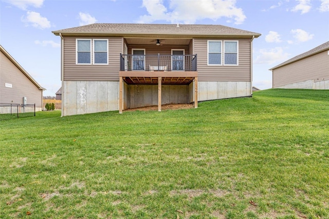 back of house with a lawn and ceiling fan