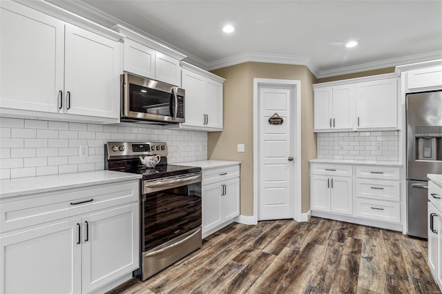 kitchen with white cabinets, stainless steel appliances, and tasteful backsplash