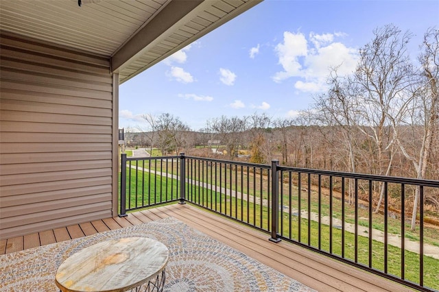 wooden deck featuring a lawn