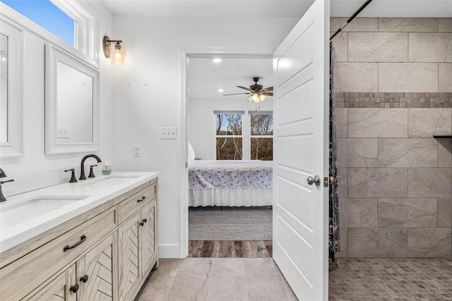 bathroom featuring ceiling fan and vanity