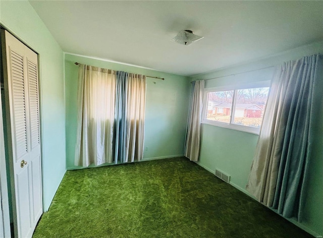 unfurnished bedroom featuring carpet floors, a closet, and visible vents