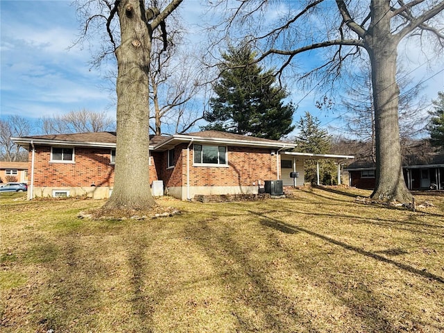 single story home featuring cooling unit, brick siding, and a front lawn