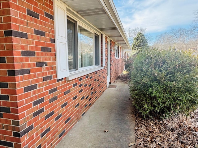 view of side of home with brick siding