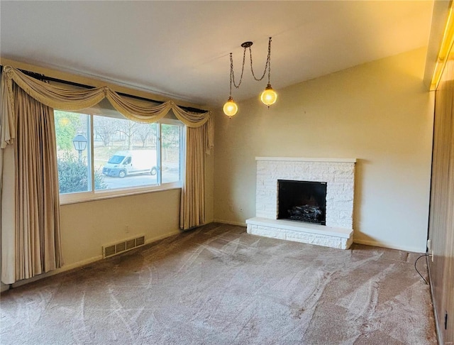 unfurnished living room featuring carpet, a fireplace, and visible vents