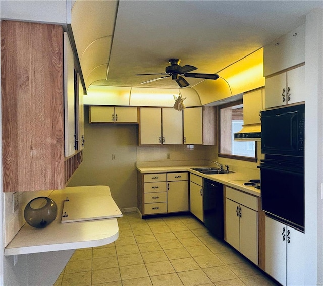 kitchen with ceiling fan, a sink, light countertops, decorative backsplash, and black appliances