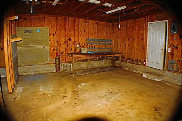 garage with wood walls and a workshop area