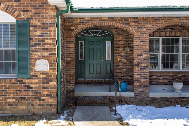 view of snow covered property entrance