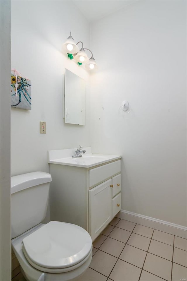 bathroom featuring toilet, tile patterned floors, and vanity