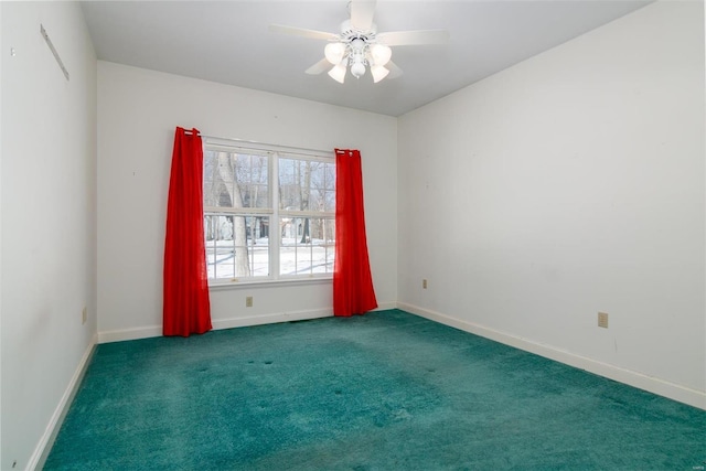 spare room featuring ceiling fan and dark carpet