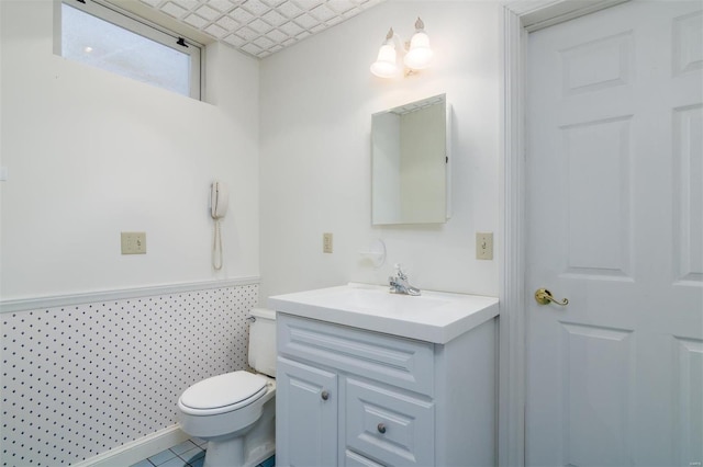 bathroom featuring vanity, toilet, and tile patterned flooring