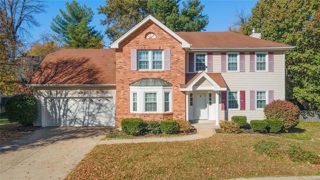 view of front of home with a garage and a front lawn