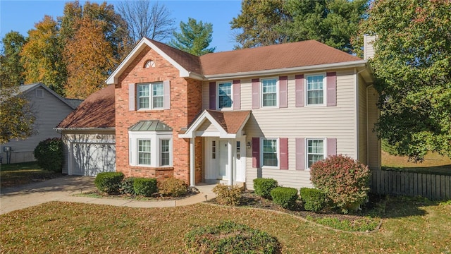 view of front of house featuring a garage and a front lawn