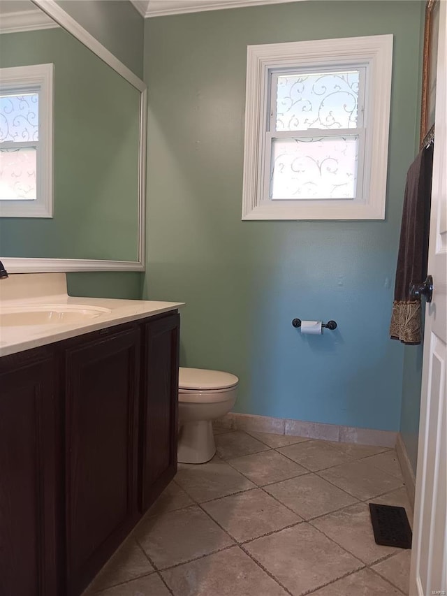 bathroom featuring vanity, a healthy amount of sunlight, and toilet