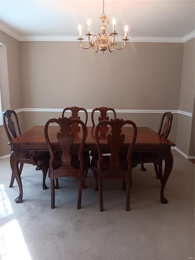 carpeted dining room with crown molding and an inviting chandelier