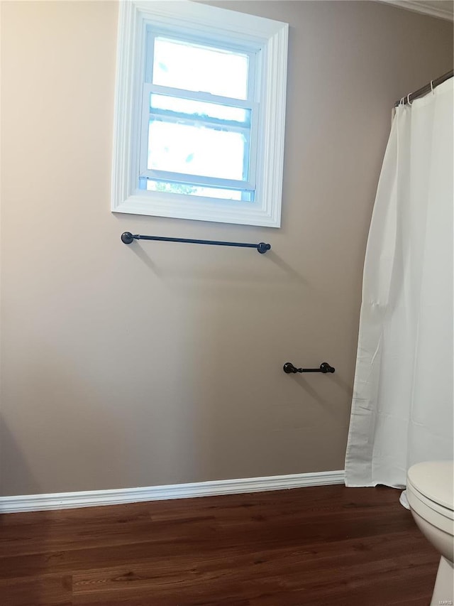 bathroom featuring hardwood / wood-style flooring and toilet