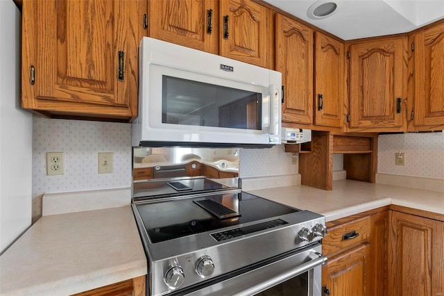 kitchen featuring decorative backsplash and stainless steel electric range