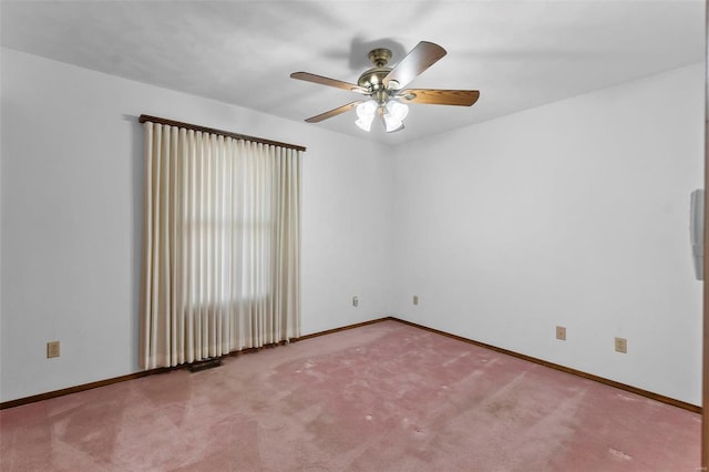 carpeted empty room featuring ceiling fan