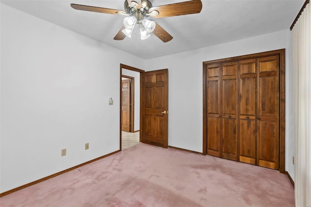 unfurnished bedroom featuring light colored carpet, a closet, and ceiling fan