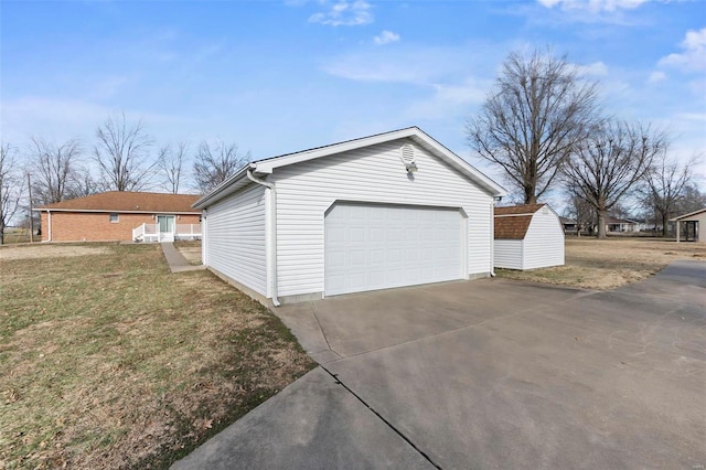 view of home's exterior with a garage, an outdoor structure, and a lawn