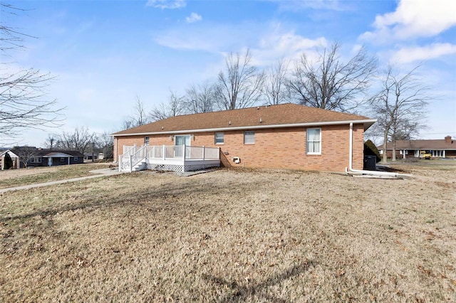 rear view of property with a lawn and a deck