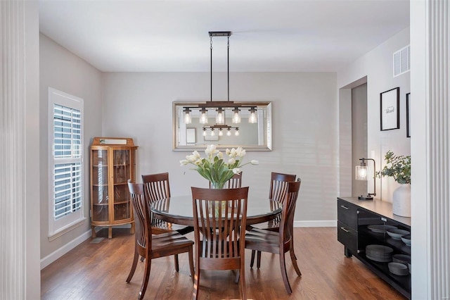 dining space with dark wood-type flooring