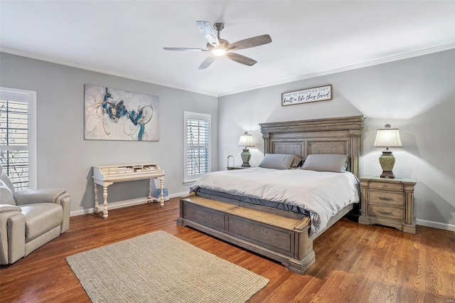 bedroom with dark hardwood / wood-style flooring, crown molding, and ceiling fan