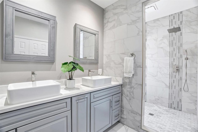 bathroom with vanity and tiled shower