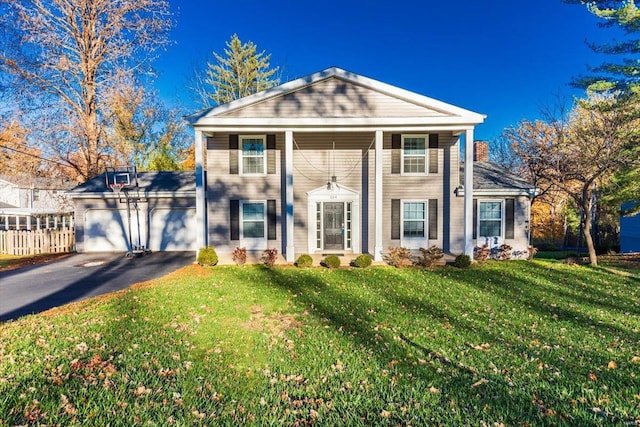 view of front of house featuring a garage and a front yard