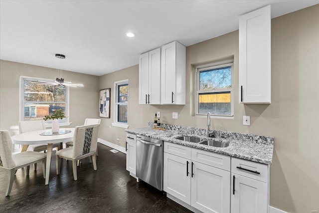 kitchen featuring sink, dishwasher, white cabinetry, light stone counters, and dark hardwood / wood-style flooring