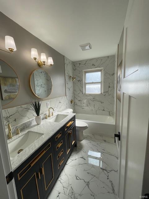 full bathroom featuring tiled shower / bath, vanity, and toilet