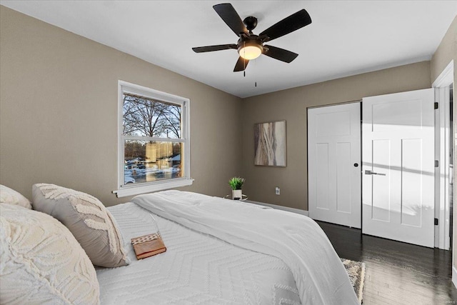 bedroom with ceiling fan and dark hardwood / wood-style flooring