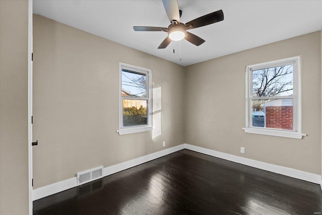 spare room with hardwood / wood-style flooring, ceiling fan, and a healthy amount of sunlight