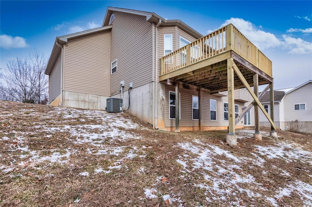 snow covered house featuring a deck