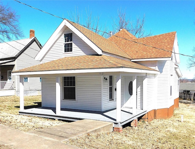 view of front of property featuring covered porch and roof with shingles