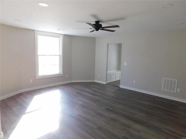 spare room with dark wood-style floors, recessed lighting, visible vents, ceiling fan, and baseboards