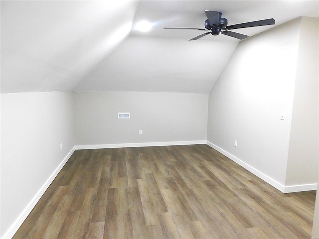 bonus room with lofted ceiling, ceiling fan, wood finished floors, visible vents, and baseboards