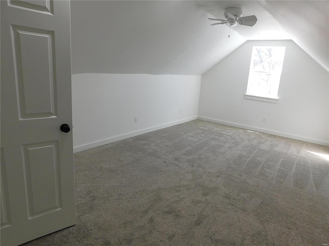 additional living space featuring lofted ceiling, ceiling fan, baseboards, and carpet flooring