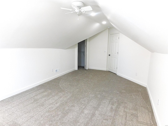 additional living space with carpet floors, lofted ceiling, ceiling fan, and baseboards