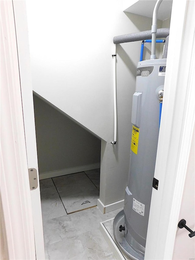 utility room featuring electric water heater