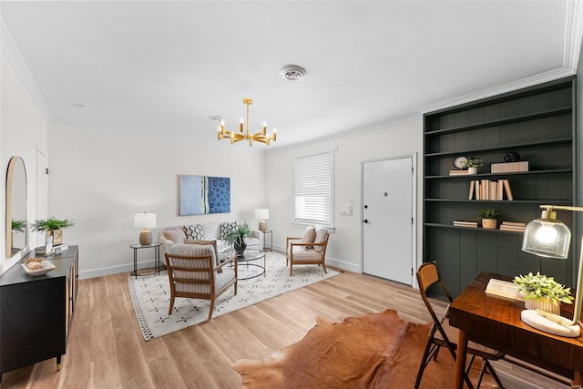 living room featuring a notable chandelier, ornamental molding, and light wood-type flooring