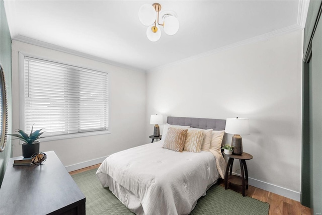 bedroom with crown molding and hardwood / wood-style floors