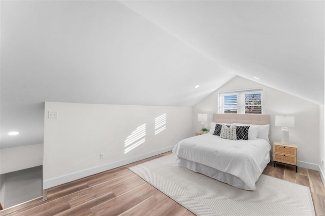 bedroom with lofted ceiling and hardwood / wood-style floors