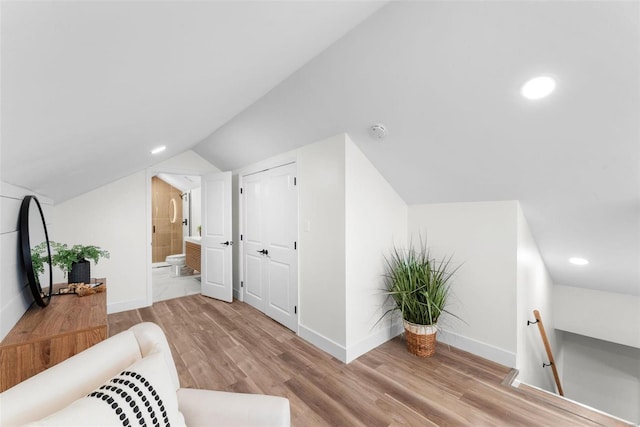 sitting room with vaulted ceiling and light hardwood / wood-style flooring