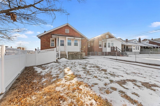 view of snow covered rear of property