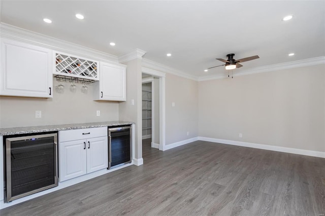 kitchen featuring wine cooler, white cabinetry, and ornamental molding